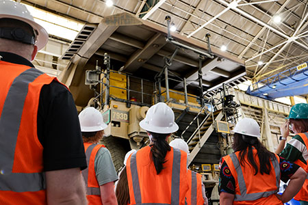 Corporate interns receive an up-close look at one of Bagdad’s autonomous haul trucks.