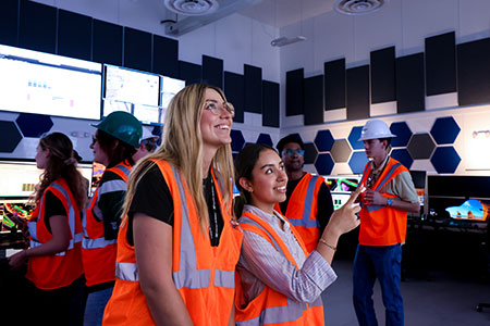Interns Isabella Cutaia (left) and Samahara Quintana Chavez take in the sights at Bagdad’s new command center.